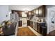 Kitchen featuring stainless steel appliances, dark cabinets, decorative backsplash and lots of counter space at 7482 N Maple Dr, Frankton, IN 46044