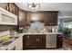 Kitchen featuring stainless steel appliances, dark cabinets, decorative backsplash and modern lighting at 7482 N Maple Dr, Frankton, IN 46044
