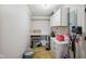 Clean laundry room with overhead cabinets, a folding table, and ample storage space at 7482 N Maple Dr, Frankton, IN 46044
