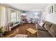 Cozy living room with hardwood floors, lots of light and a comfortable sofa at 7482 N Maple Dr, Frankton, IN 46044