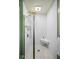 A modern shower with sleek subway tile, a glass door, a built-in bench, and a rainfall shower head at 7482 N Maple Dr, Frankton, IN 46044