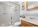 Clean bathroom with a shower stall, oak vanity, and soft lighting, creating a refreshing and functional space at 7709 Lewis Rd, Indianapolis, IN 46256