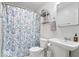 Stylish bathroom with a floral shower curtain, modern fixtures, and ample lighting, providing a fresh and clean ambiance at 7709 Lewis Rd, Indianapolis, IN 46256