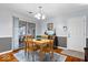 Charming dining room featuring a wood table and a blue patterned rug, leading to the outdoor patio with sliding door at 7709 Lewis Rd, Indianapolis, IN 46256