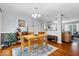Cozy dining area with hardwood floors, chandelier lighting, and an open layout to the living room at 7709 Lewis Rd, Indianapolis, IN 46256