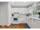 Bright kitchen with white cabinets, modern appliances, and hardwood floors, creating a clean and functional cooking space at 7709 Lewis Rd, Indianapolis, IN 46256