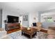 Well-lit living room with an entertainment center, comfortable seating, and modern decor at 7709 Lewis Rd, Indianapolis, IN 46256