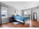 Inviting main bedroom with a comfortable bed, natural light from windows, and hardwood floors for a cozy retreat at 7709 Lewis Rd, Indianapolis, IN 46256