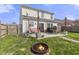 Relaxing backyard with patio seating, fire pit, and a well-maintained lawn at 8158 Wheatfield Ct, Camby, IN 46113
