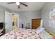 Neutral bedroom with a quilt-covered bed, dresser, and access to an en-suite bathroom at 8158 Wheatfield Ct, Camby, IN 46113