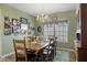 Warm dining room with an inviting wooden table, decorative chandelier, and natural light from the window at 8158 Wheatfield Ct, Camby, IN 46113