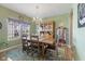 Inviting dining room featuring a wooden table set, chandelier lighting, and decorative hutch at 8158 Wheatfield Ct, Camby, IN 46113
