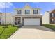 Two story home featuring brick and vinyl siding, an attached two car garage and a concrete driveway at 8158 Wheatfield Ct, Camby, IN 46113