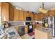 Kitchen featuring stainless steel appliances, wood cabinets, and decorative backsplash at 8158 Wheatfield Ct, Camby, IN 46113