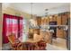 Eat-in kitchen featuring wood cabinets, an island, and backyard access at 8158 Wheatfield Ct, Camby, IN 46113