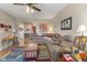 Spacious living room with hardwood floors, comfortable seating, and a large window at 8158 Wheatfield Ct, Camby, IN 46113