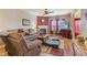 Cozy living room featuring a fireplace, comfortable seating, and a large window at 8158 Wheatfield Ct, Camby, IN 46113