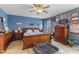 Stylish main bedroom featuring hardwood furniture, a ceiling fan, and decorative items at 8158 Wheatfield Ct, Camby, IN 46113