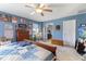 Comfortable main bedroom featuring a ceiling fan, wooden accents, and natural light at 8158 Wheatfield Ct, Camby, IN 46113
