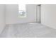 A bright bedroom featuring a light-colored carpet, a window, and an ensuite door at 827 Allandale Ave, Westfield, IN 46074