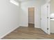 Well-lit bedroom with wood-look floors, white walls, closet and bright natural light at 827 Allandale Ave, Westfield, IN 46074