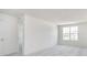 Bright bedroom featuring neutral carpet, a window, and an entry door at 827 Allandale Ave, Westfield, IN 46074