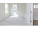 Bright bedroom with neutral carpet, natural light from two windows, and a stylish interior door at 827 Allandale Ave, Westfield, IN 46074