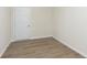 Bright bedroom featuring neutral walls, light wood-look floors, and a white door at 827 Allandale Ave, Westfield, IN 46074