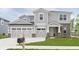 Charming two-story home featuring a two-car garage, brick accents, and landscaped front yard at 827 Allandale Ave, Westfield, IN 46074