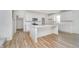 Modern white kitchen with a center island, stainless steel appliances, and wood-look flooring at 827 Allandale Ave, Westfield, IN 46074