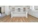 Stylish kitchen with a large island, white cabinets, stainless steel appliances, and wood flooring at 827 Allandale Ave, Westfield, IN 46074