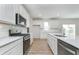 Well-lit kitchen with white cabinets, stainless steel appliances, a center island, and wood flooring at 827 Allandale Ave, Westfield, IN 46074