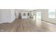 Spacious open-concept living area with wood-look flooring connecting to a modern kitchen at 827 Allandale Ave, Westfield, IN 46074