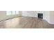 Open-concept living room with wood-look floors and a fireplace at 827 Allandale Ave, Westfield, IN 46074