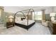 Serene main bedroom with a four-poster bed, soft lighting, and a relaxing atmosphere at 827 Allandale Ave, Westfield, IN 46074