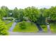 Expansive grounds and circular driveway accent this property's mature trees and verdant lawns at 8535 Washington Blvd, Indianapolis, IN 46240