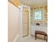 Bathroom with a tiled shower stall and a window with white shutters at 8535 Washington Blvd, Indianapolis, IN 46240