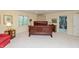 Spacious bedroom with a large, wood-framed bed and a view of a walk-in closet at 8535 Washington Blvd, Indianapolis, IN 46240