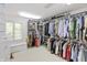 Organized walk-in closet with built-in shelving, hanging racks, and a window seat at 8535 Washington Blvd, Indianapolis, IN 46240