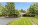 Traditional brick home boasts mature trees, green lawns, and a winding driveway at 8535 Washington Blvd, Indianapolis, IN 46240