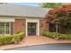 Elegant brick home features a double-door entryway and manicured landscaping at 8535 Washington Blvd, Indianapolis, IN 46240