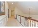 Bright hallway featuring elegant trim work, chandelier, and carpet flooring at 8535 Washington Blvd, Indianapolis, IN 46240