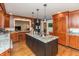 Modern kitchen with island, granite countertops, stainless appliances, and hardwood floors at 8535 Washington Blvd, Indianapolis, IN 46240