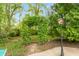 Stone path leading to green archway, surrounded by lush landscaping with a street light in the foreground at 8535 Washington Blvd, Indianapolis, IN 46240