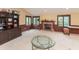 Cozy living room with a brick fireplace, a built-in entertainment center, and large windows at 8535 Washington Blvd, Indianapolis, IN 46240