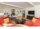 Open living room featuring a brick fireplace, hardwood floors, and comfortable seating at 8535 Washington Blvd, Indianapolis, IN 46240