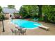 Backyard pool, patio with furniture, and landscaping around the home and property at 8535 Washington Blvd, Indianapolis, IN 46240