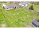 Aerial view of property showing large grassy backyard, perimeter fence, wooden deck and storage shed at 8621 Manderley Dr, Indianapolis, IN 46240