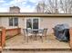 Wood deck with outdoor table and chairs, a grill, and sliding door entrance to home at 8621 Manderley Dr, Indianapolis, IN 46240