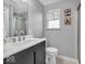Modern bathroom featuring sleek vanity, toilet, and shower with glass doors, offering a clean aesthetic at 8621 Manderley Dr, Indianapolis, IN 46240